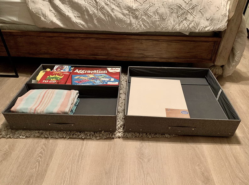 two bins holding board games and extra linens