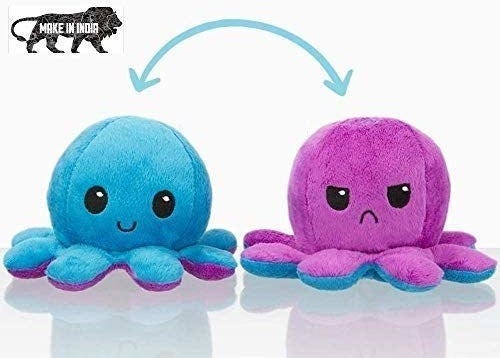 A set of reversible octopus plushie in blue and purple with one showing a happy face and the other showing an angry face