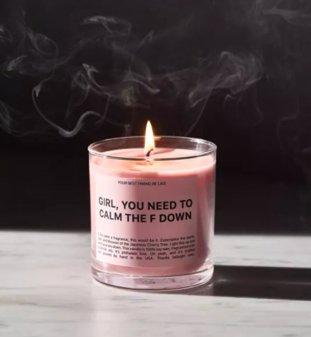 A lit candle that says girl, you need to calm the f down