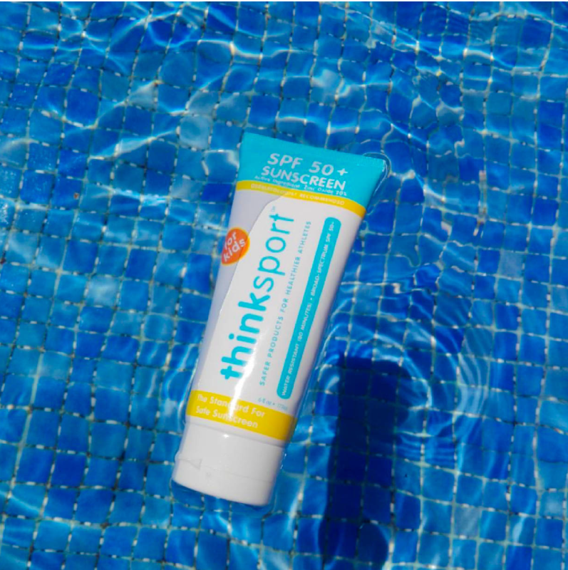 white tube of sunscreen in a pool