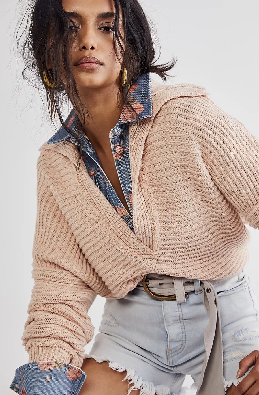 the sweater in dusty pink layered with a patterned denim shirt underneath