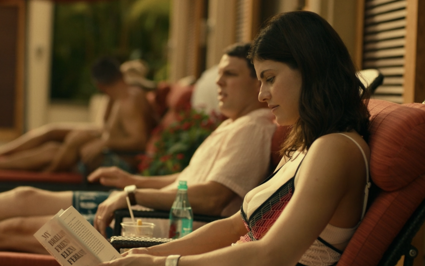 Rachel reads poolside in chaise