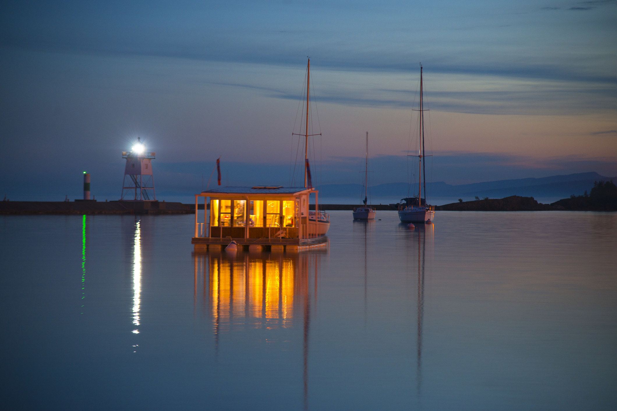 Houseboat lite up on Lake Superior in Grand Marais Harbor, Minensota.