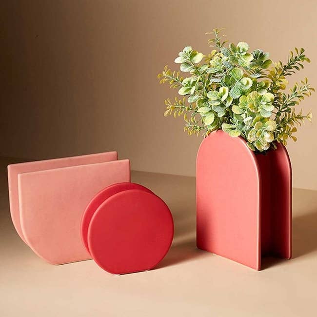 Three vases in peachy red colors and different semi-circle shapes