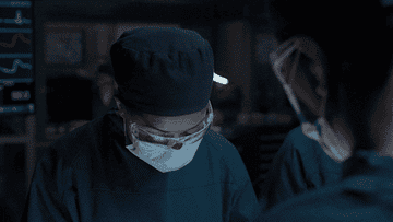 GIF of person with a surgical mask and goggles in a hospital looking up
