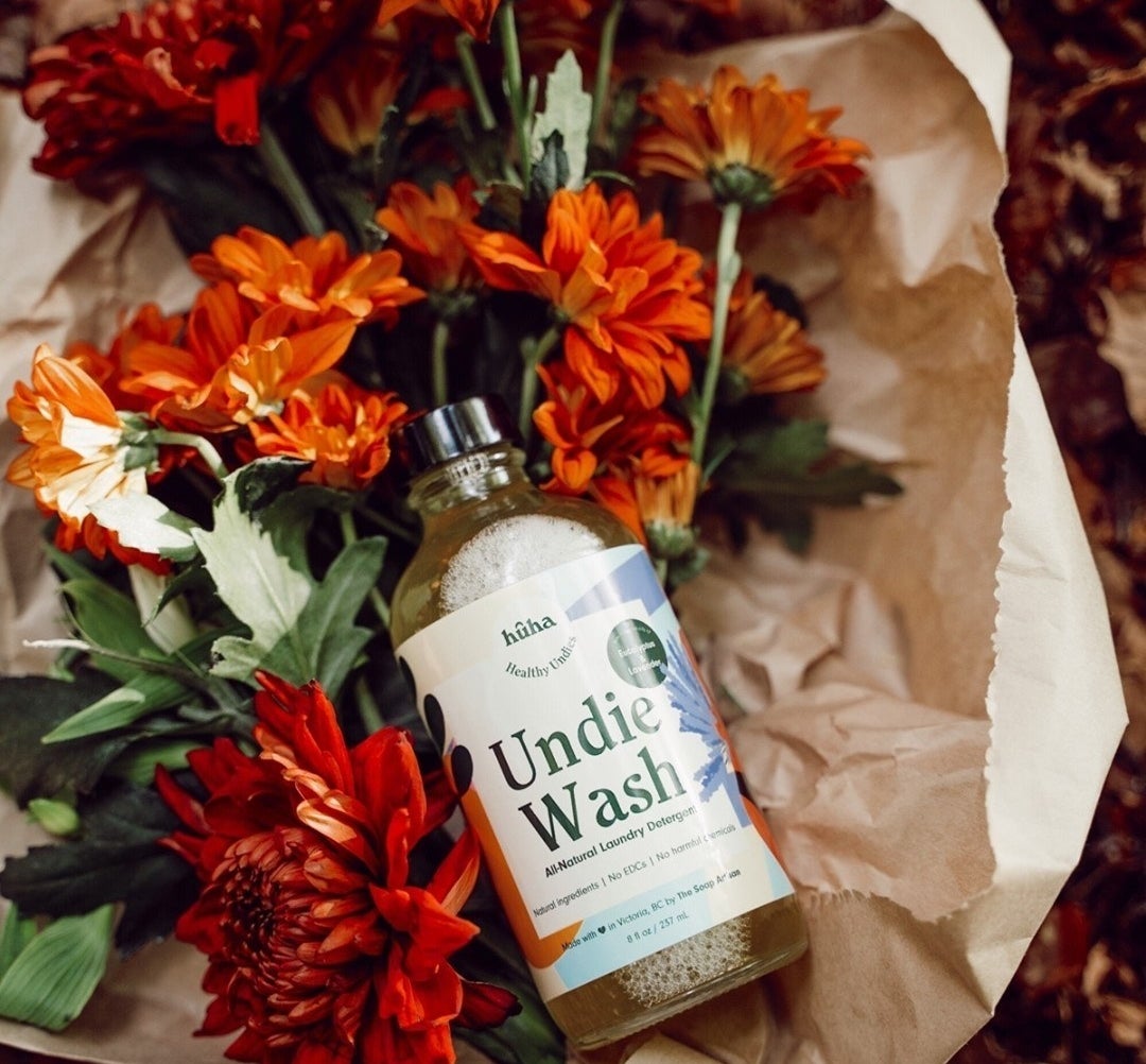 A flatlay of the undie wash on a bouquet of fresh cut flowers