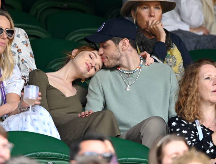 Phoebe and Peter cuddling while watching a tennis match at Wimbledon