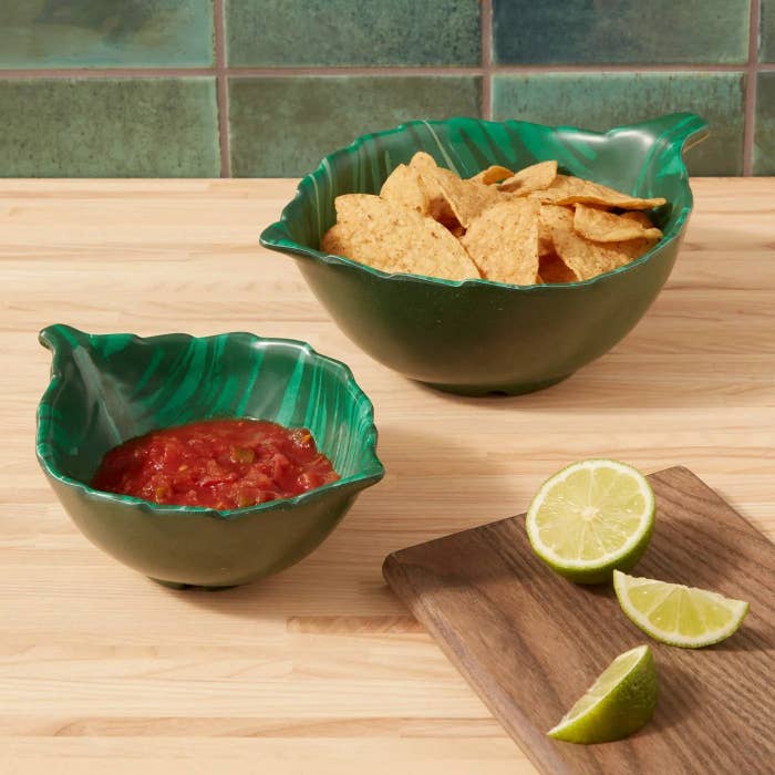 The nesting bowls shaped like bamboo leaves holding chips and salsa, respectively