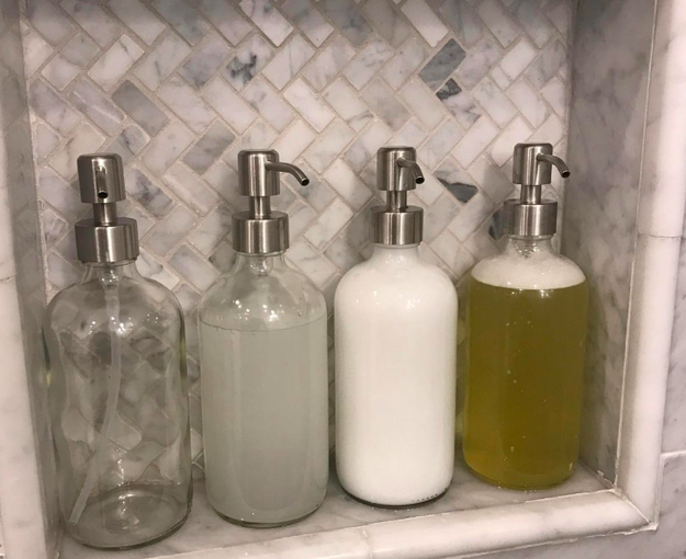 Reviewer&#x27;s four soap dispensers in their shower