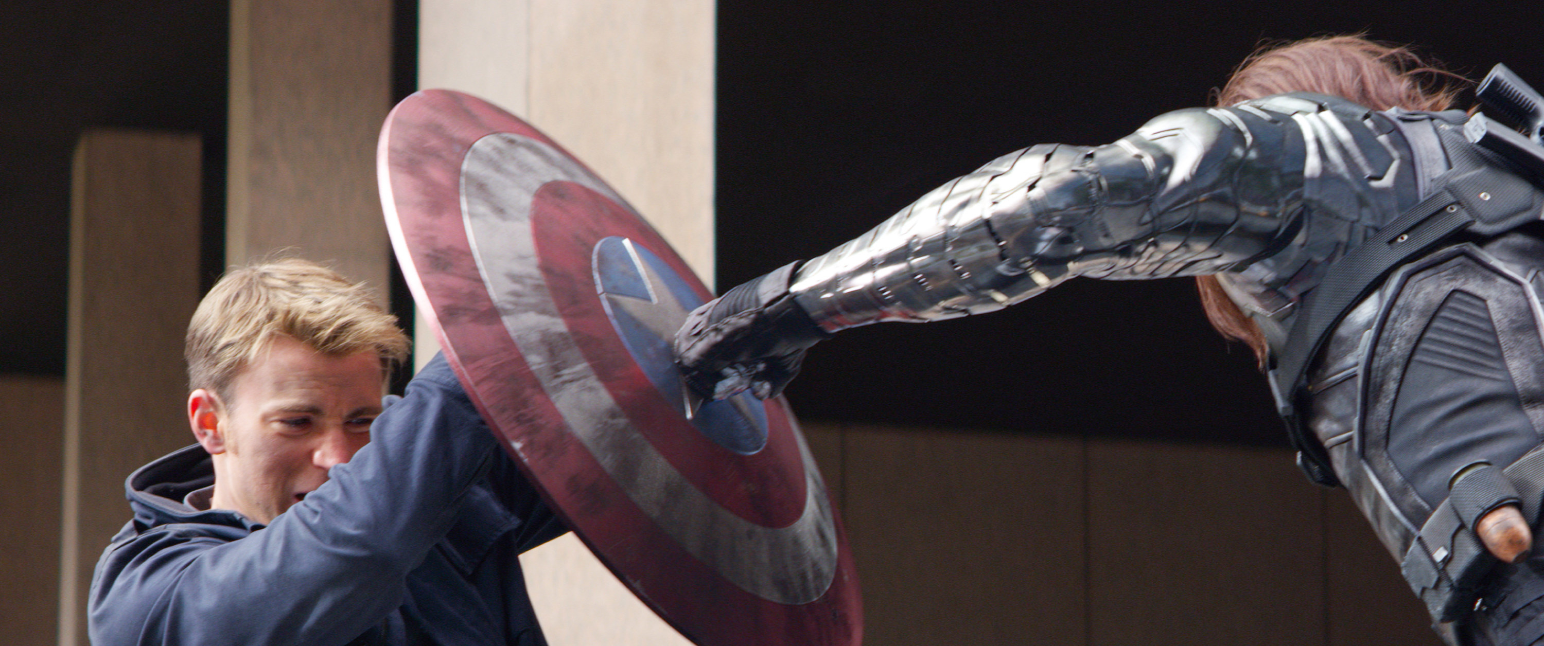 Captain America blocks a punch from The Winter Soldier with his shield.