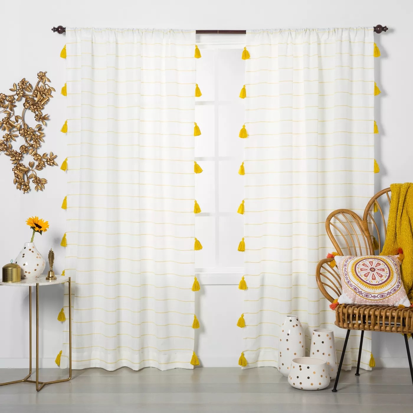The white curtains with horizontal yellow stripes and matching tassels