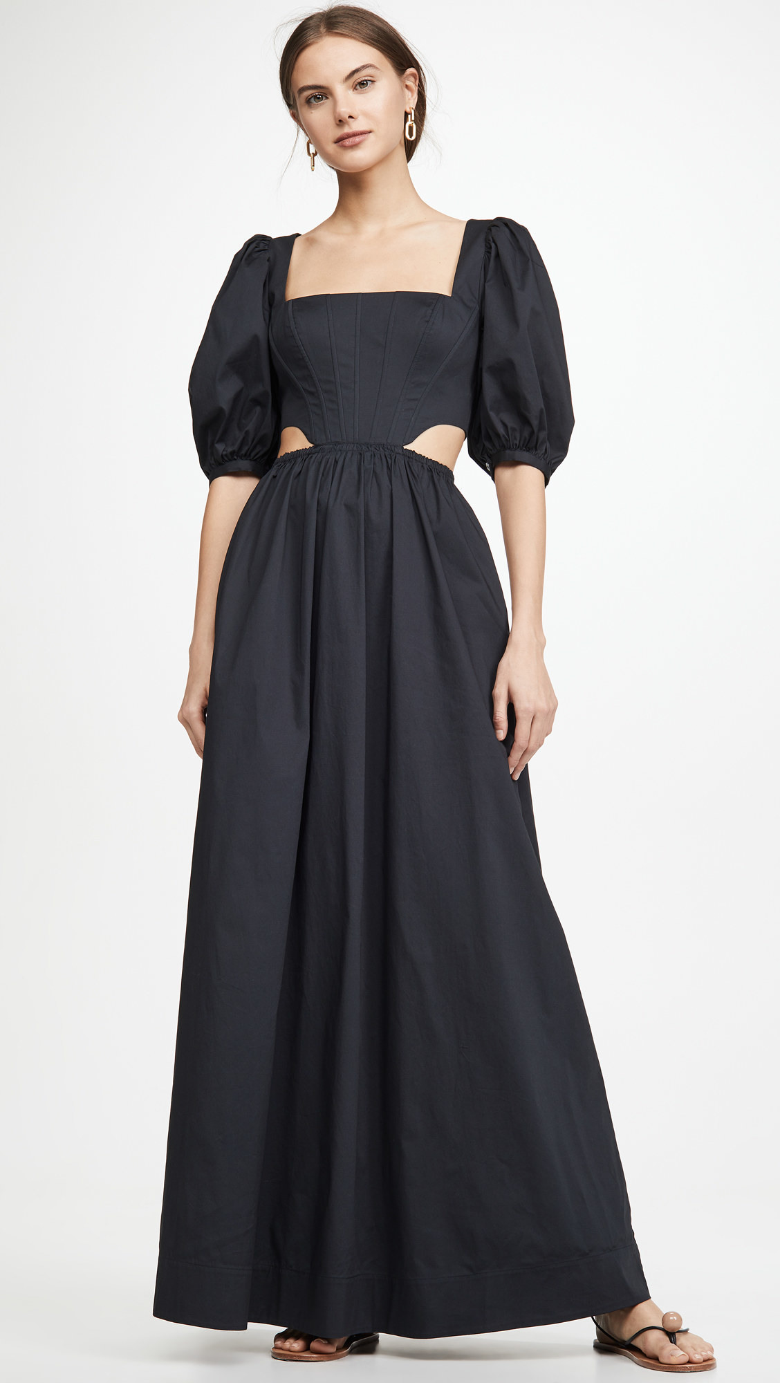 model in the puff short sleeve maxi dress with side cutouts and boning at the bodice