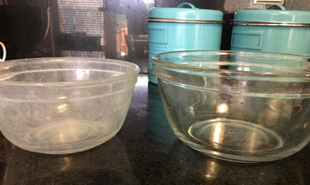 on the left, a clear bowl looking fogged up and dirty, and on the right, a clear bowl actually looking clear after using the hard water powder