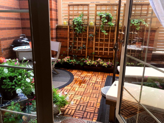 Backyard patio covered with the tiles 