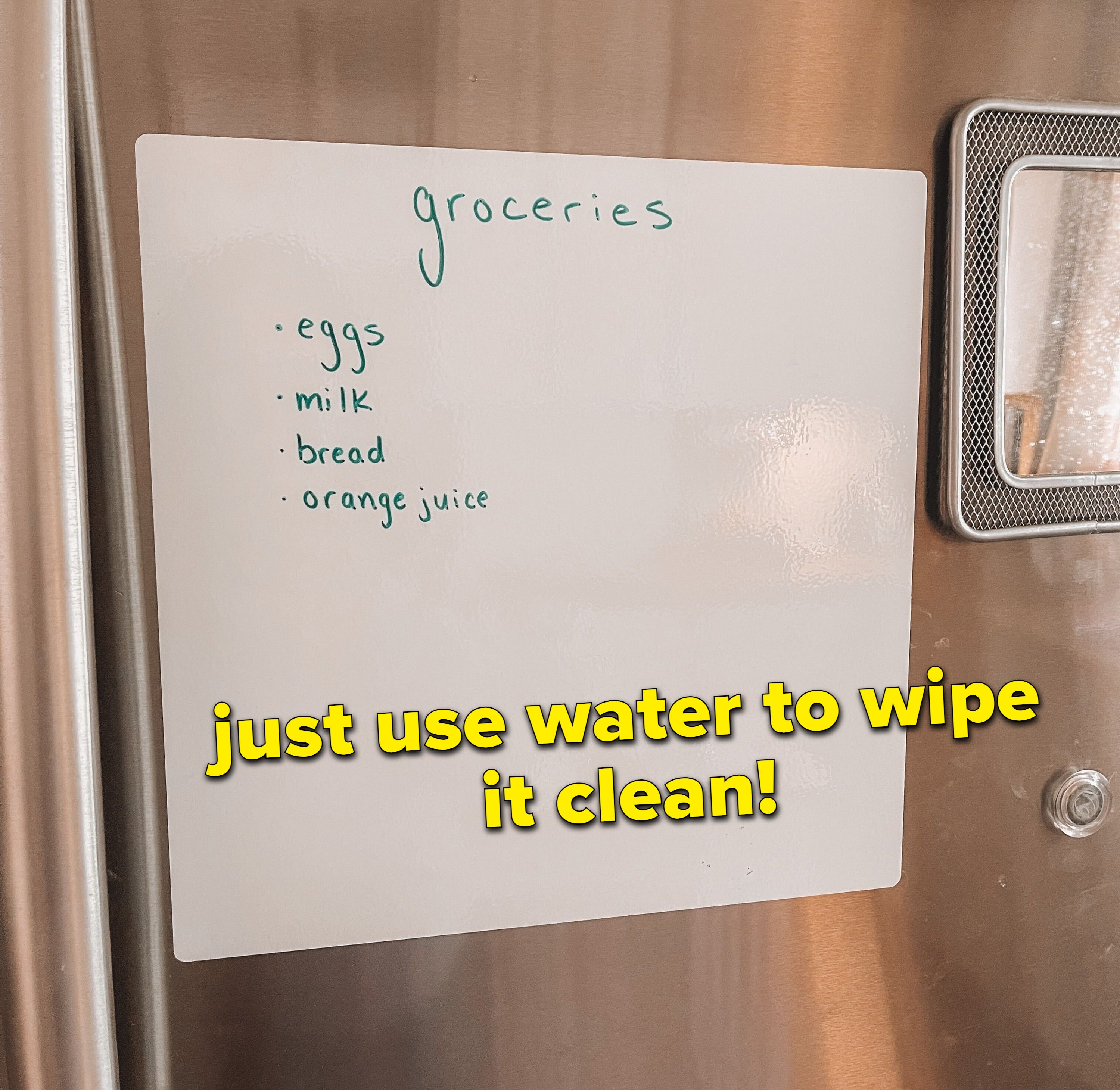 The white board on a stainless steel fridge that says &quot;groceries: eggs, milk, bread, and orange juice&quot; in list format