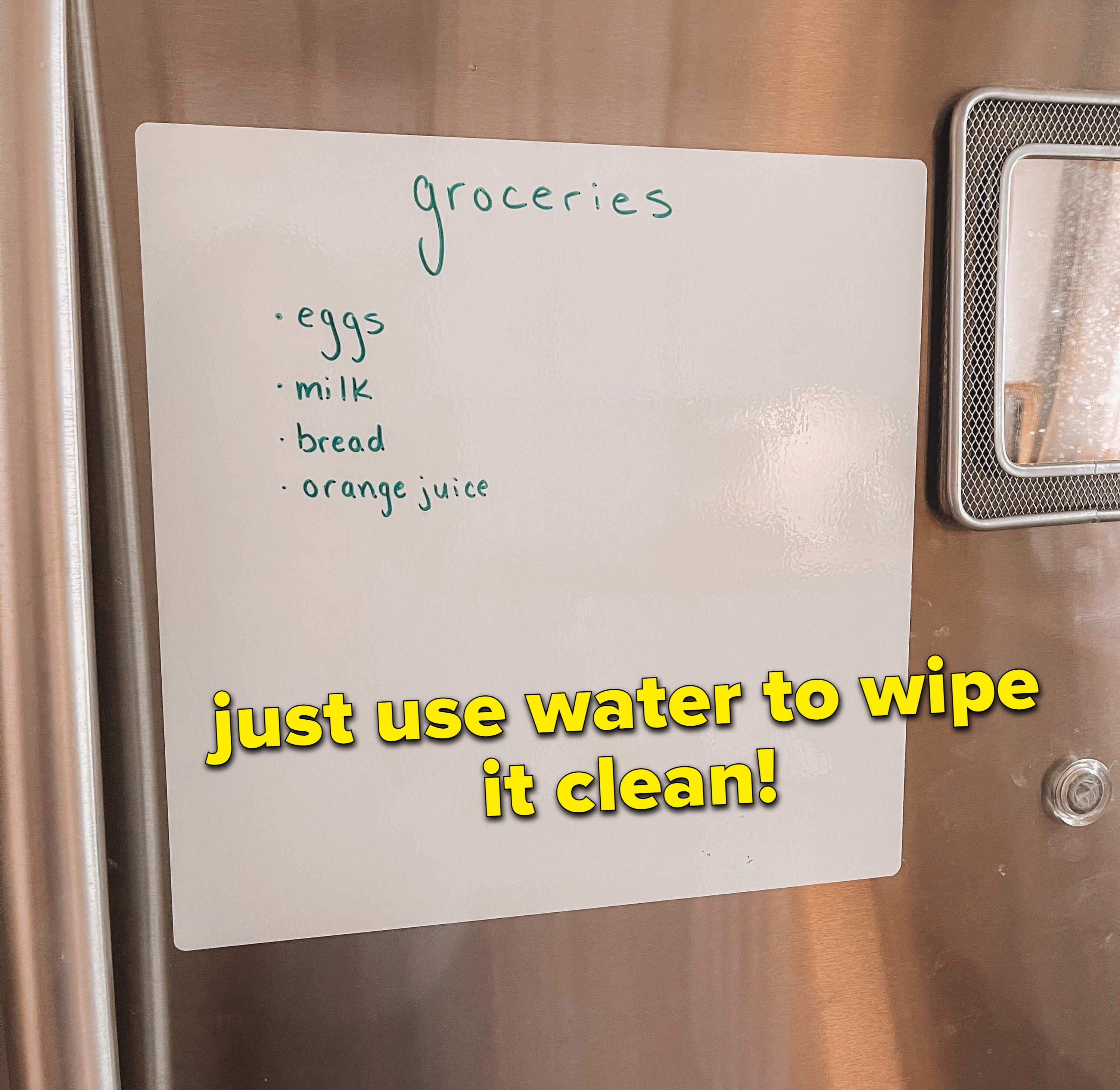 The white board on a stainless steel fridge that says &quot;groceries: eggs, milk, bread, and orange juice&quot; in list format