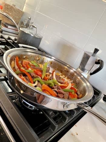writer Kayla Suazo cooking veggies and stir fry in wok