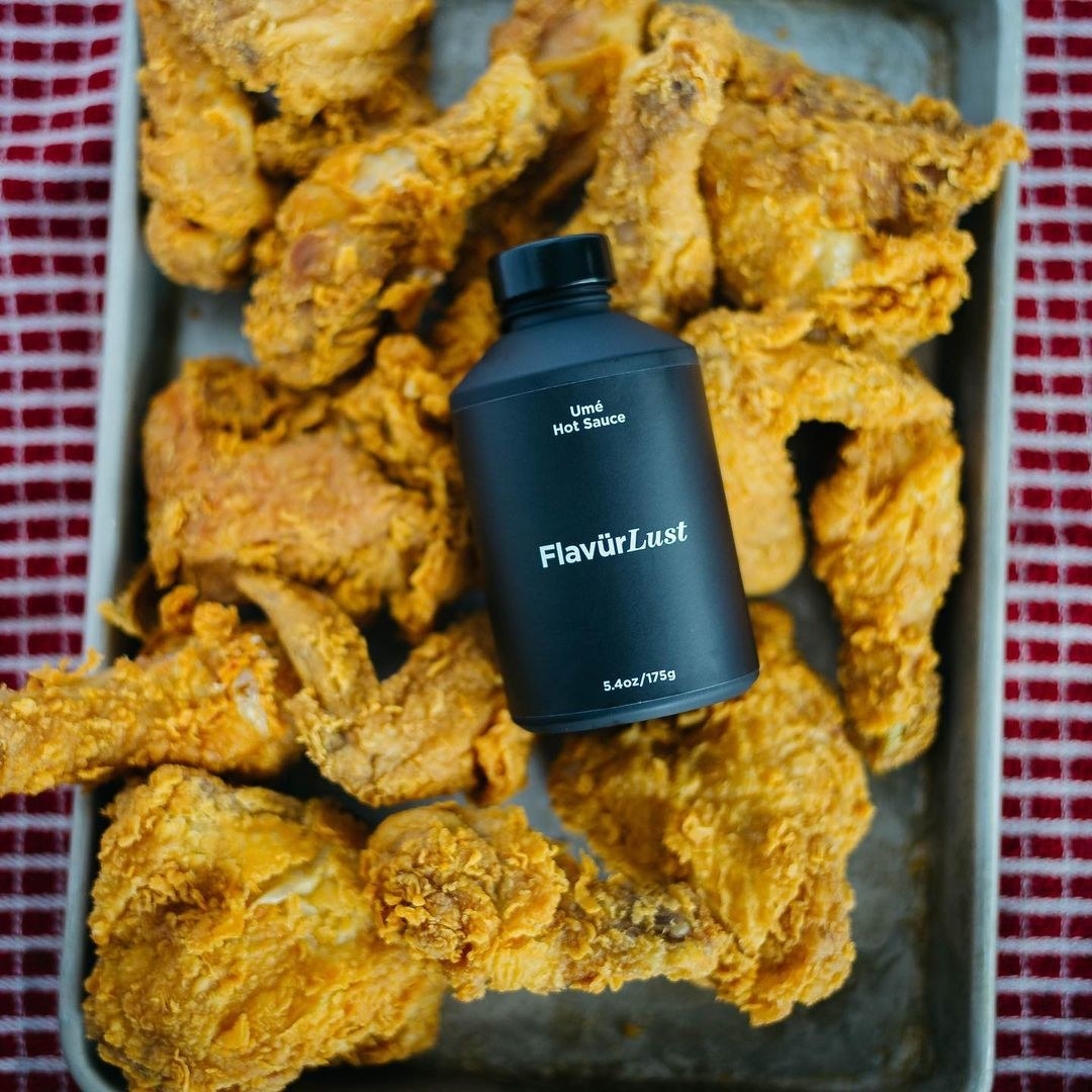 The hot sauce on a tray of fried chicken