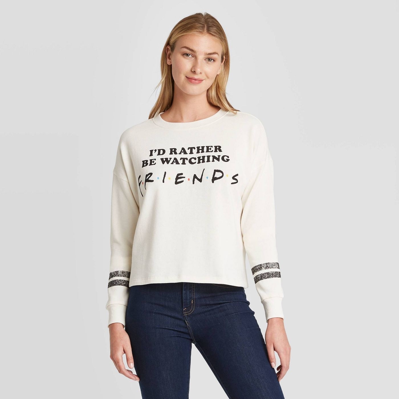 a model wearing the cropped &quot;I&#x27;d rather be watching friends&quot; graphic sweatshirt