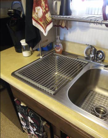 the drying rack fully rolled out over a kitchen sink 