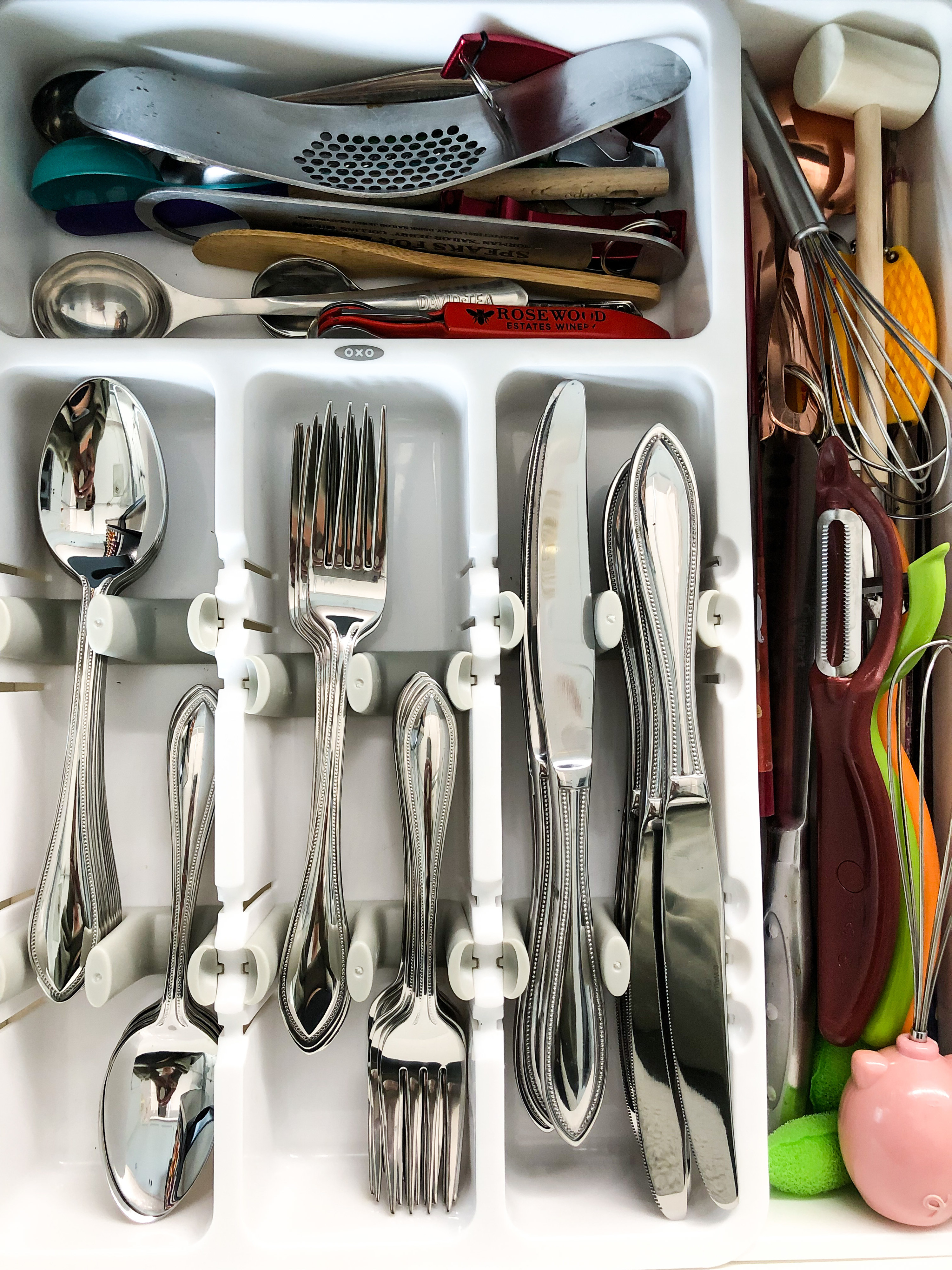 A top-down view of the cutlery organizer; all the forks and knives are neatly arranged