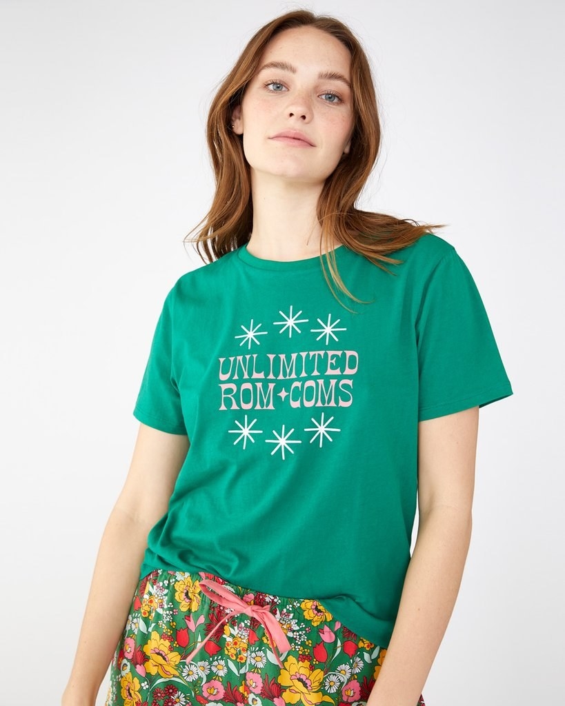 a model wearing the green &quot;unlimited rom com&quot; t-shirt