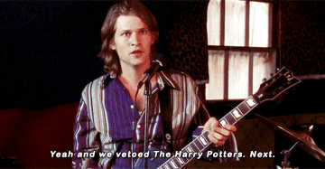 Zach with a guitar and microphone saying &quot;yeah and we vetoed The Harry Potters, next&quot;