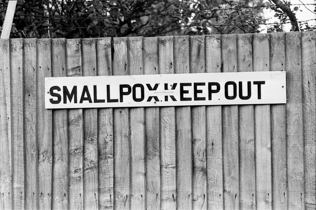 A sign on a hospital fence reading Smallpox Keep Out