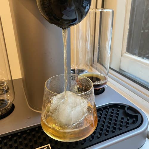 A picture from BuzzFeed Editor Hannah Loewentheil of the machine brewing a cocktail into a glass