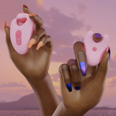 Model holding pink and coral vibrator and wireless remote