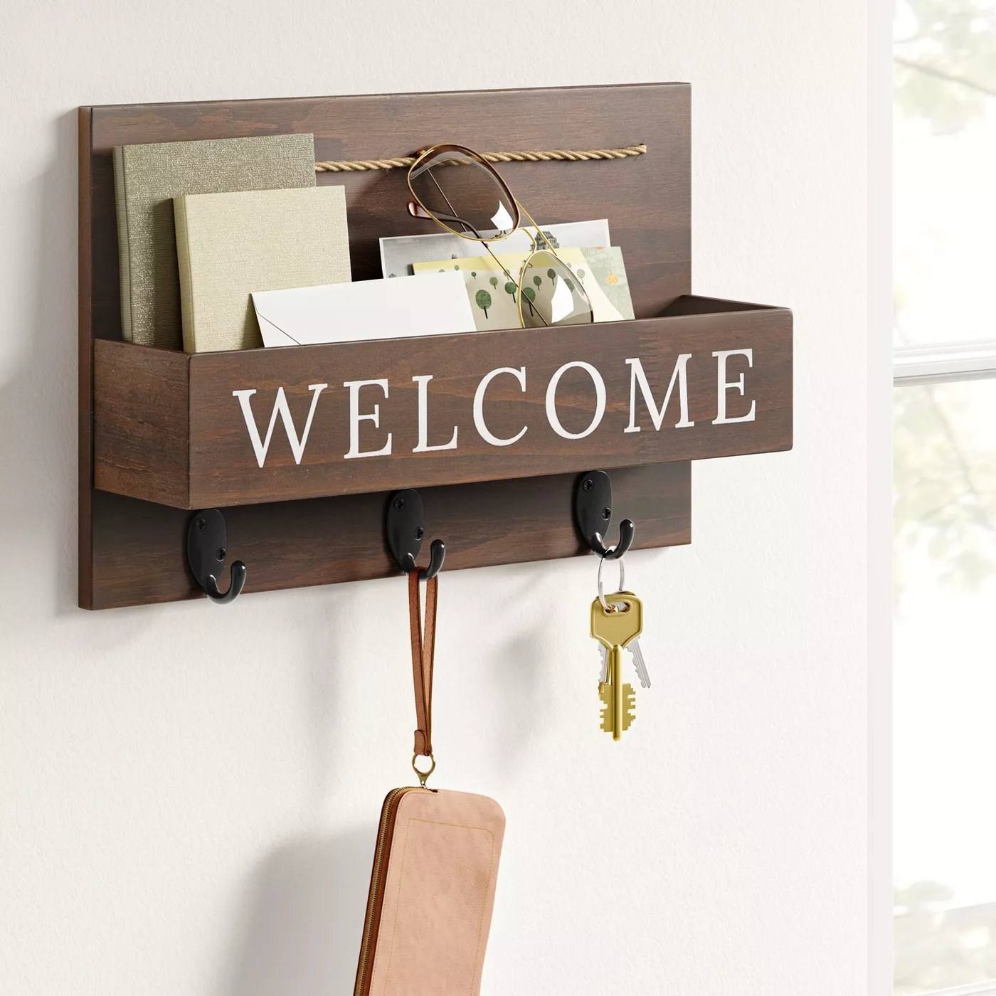 The &quot;Welcome&quot; sign with a bin for letters and three hooks underneath