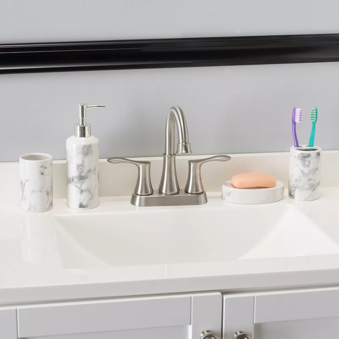 A marble soap pump, soap dish, toothbrush holder, and cup