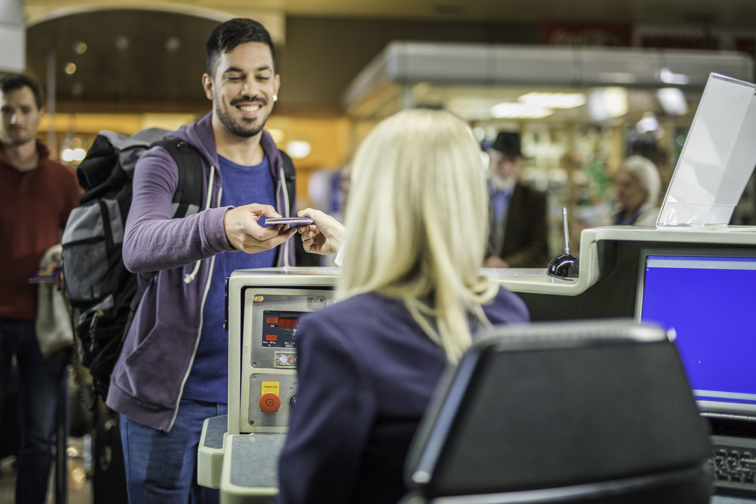 Man hands passport to gate agent at the airport