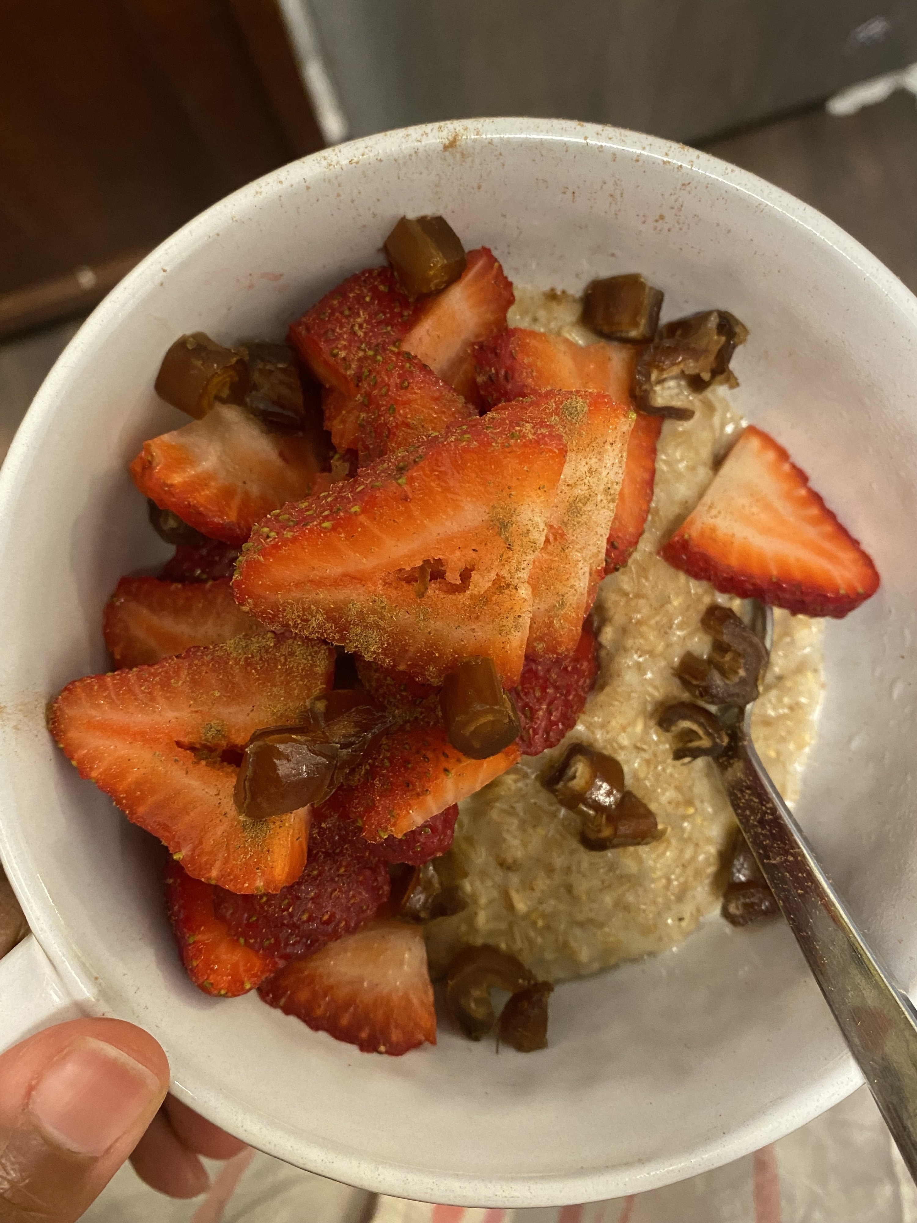 Bowl of oatmeal with strawberries and dates