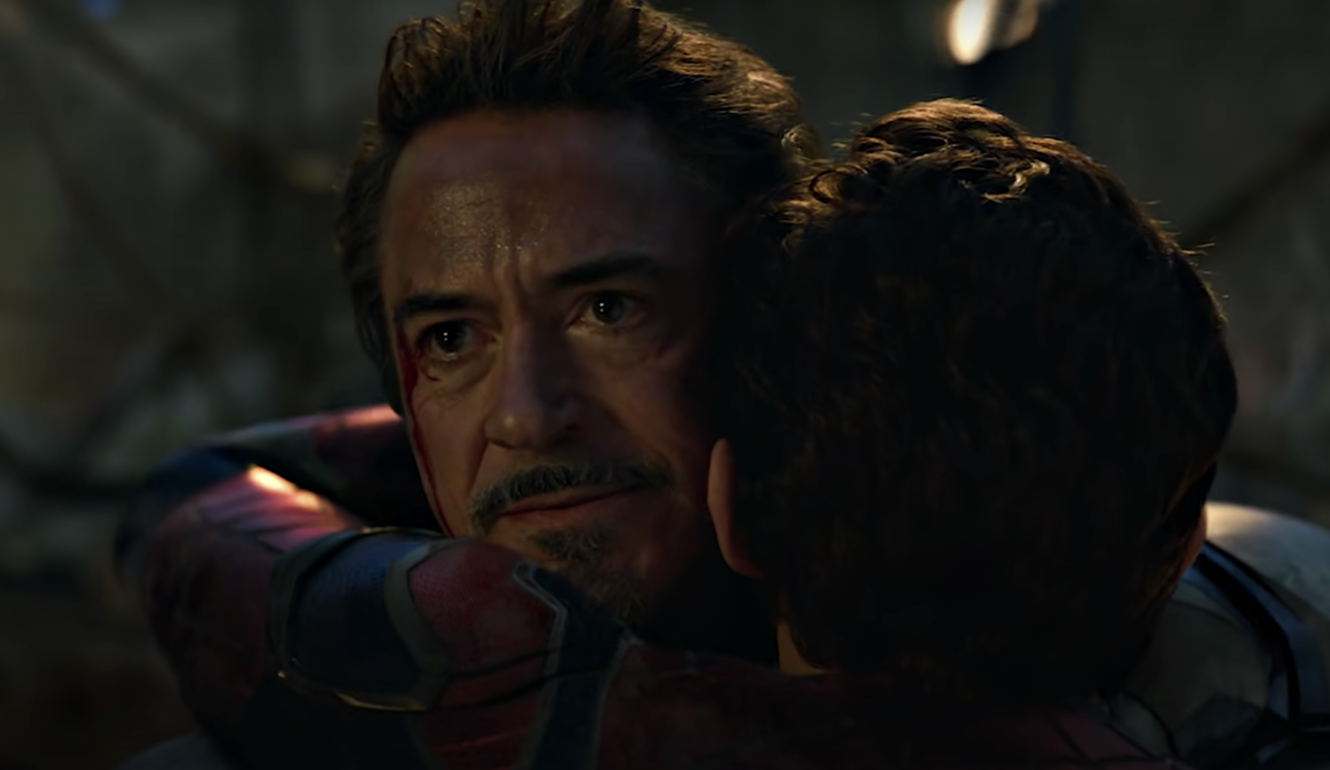 Tony Stark hugging Peter in the middle of the battle