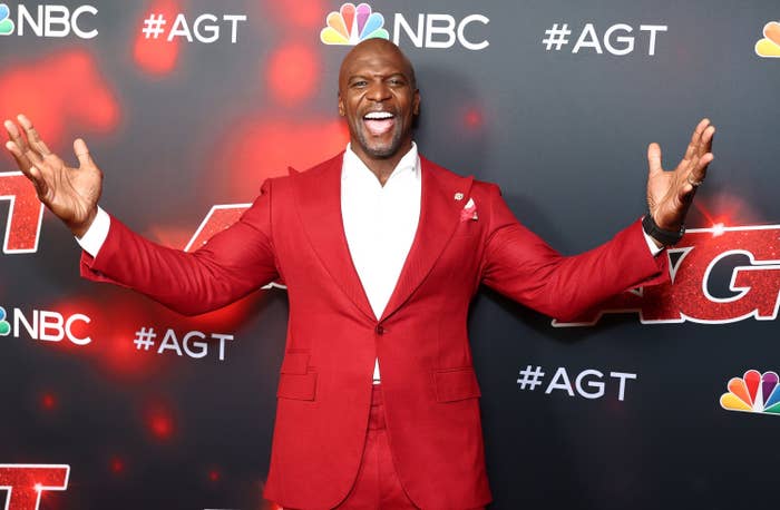 Terry Crews is photographed wearing a red suit on the America&#x27;s Got Talent red carpet  in August of 2021