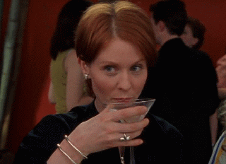 Cynthia Nixon raises a glass in a scene from Sex And The City