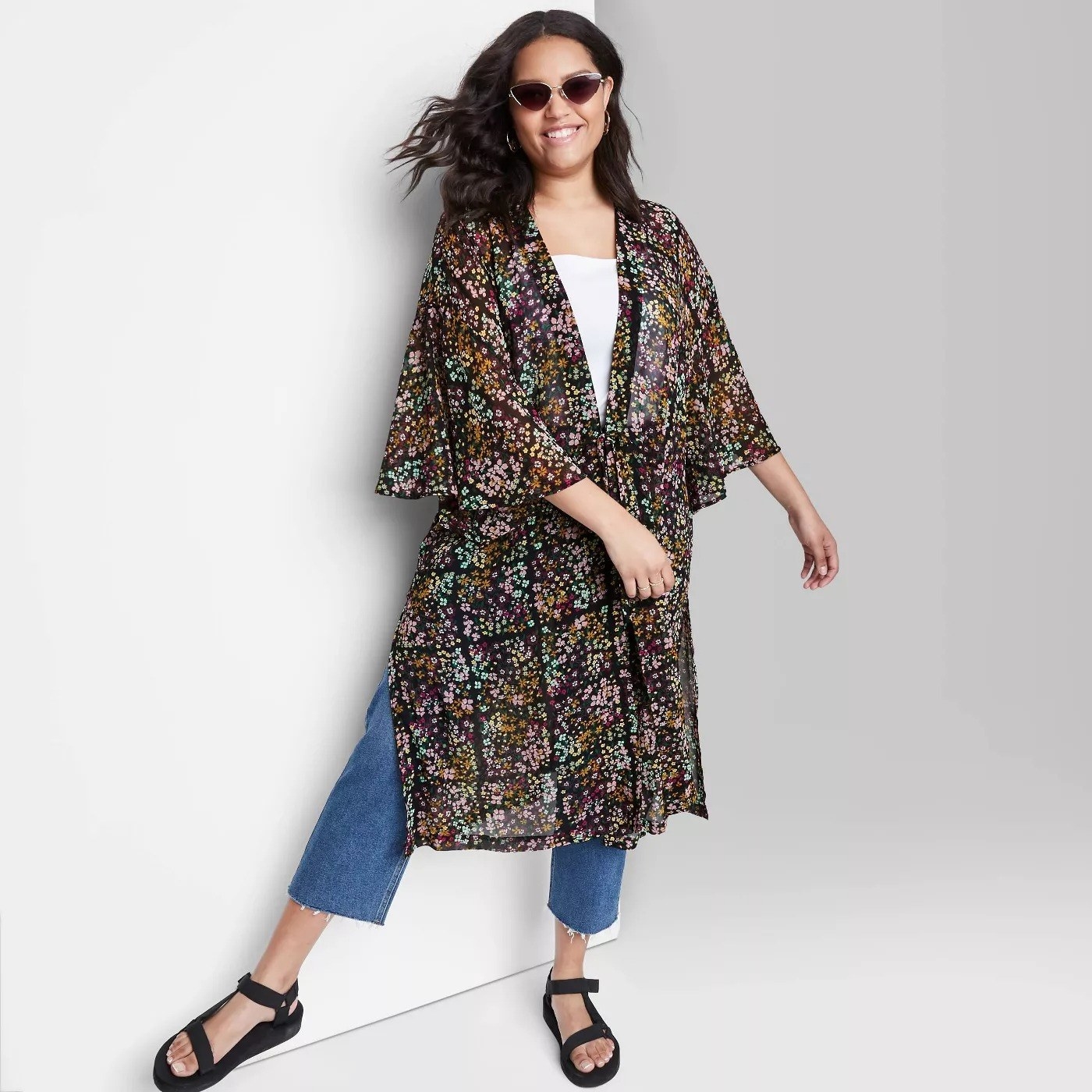 Model wearing long sleeve floral duster, stop at the knees