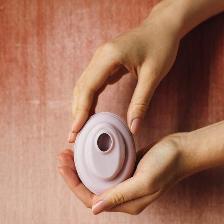 Model holding pink suction vibrator