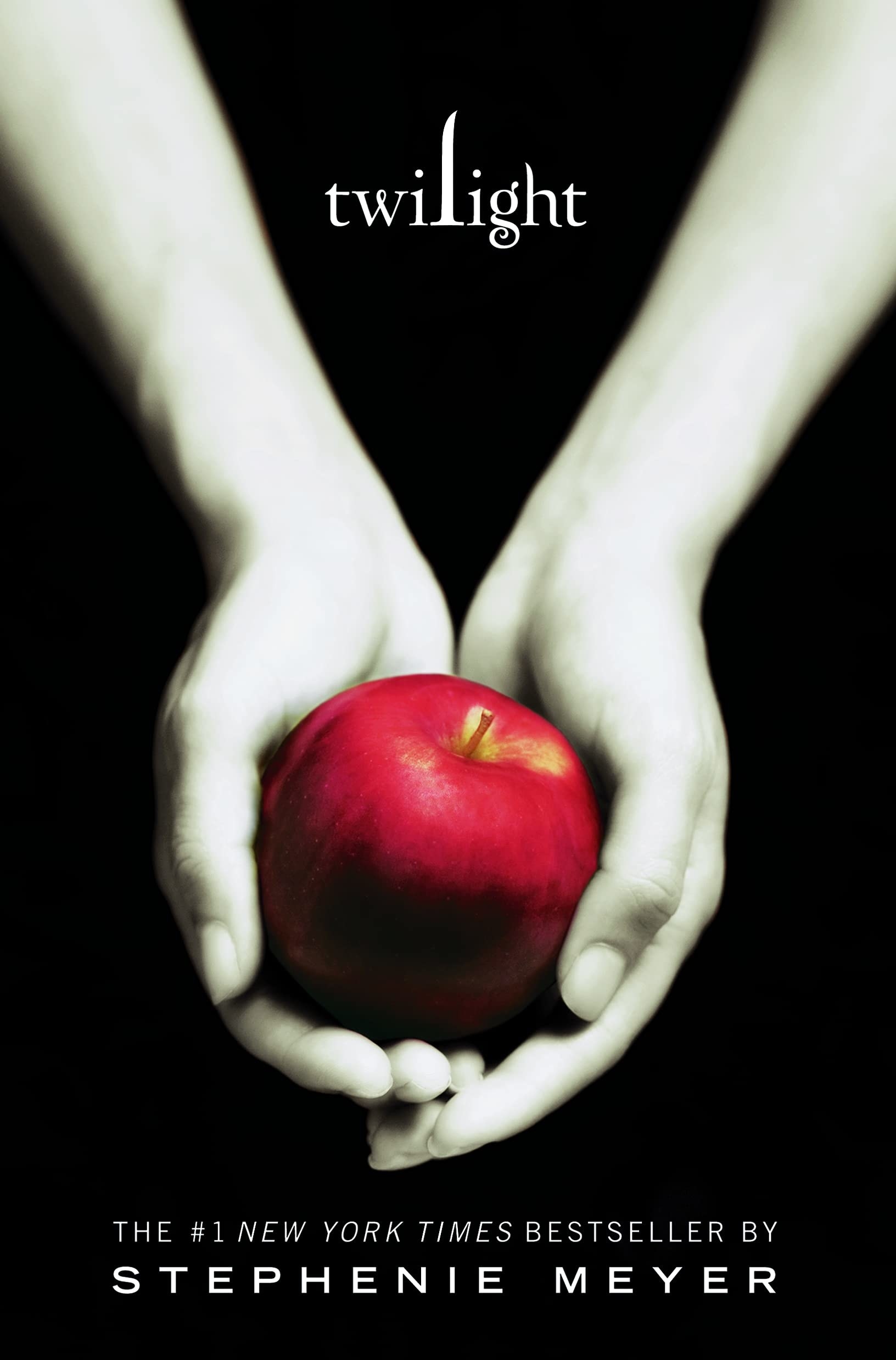 Book cover for Twilight; shows pale hands holding a red apple