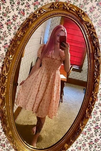 Reviewer wearing the pink dress
