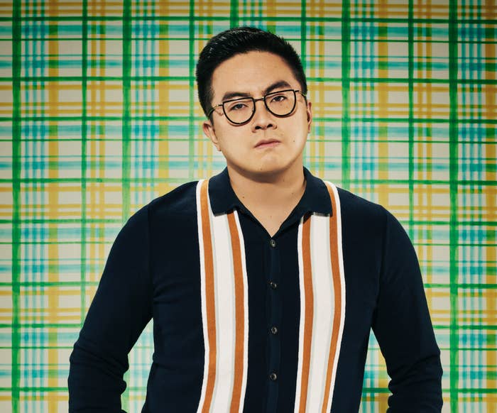 Bowen Yang looking serious against a checkered background