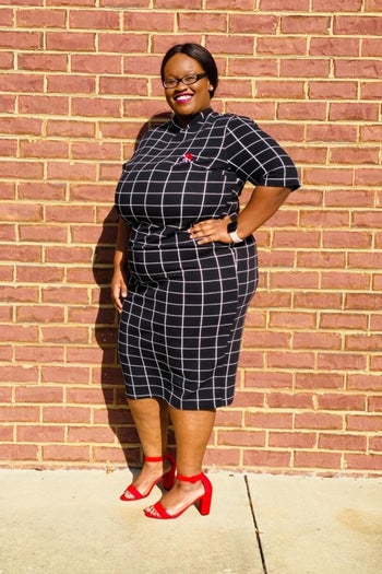 A reviewer wearing the elbow-length-sleeve dress in navy and white windowpane print