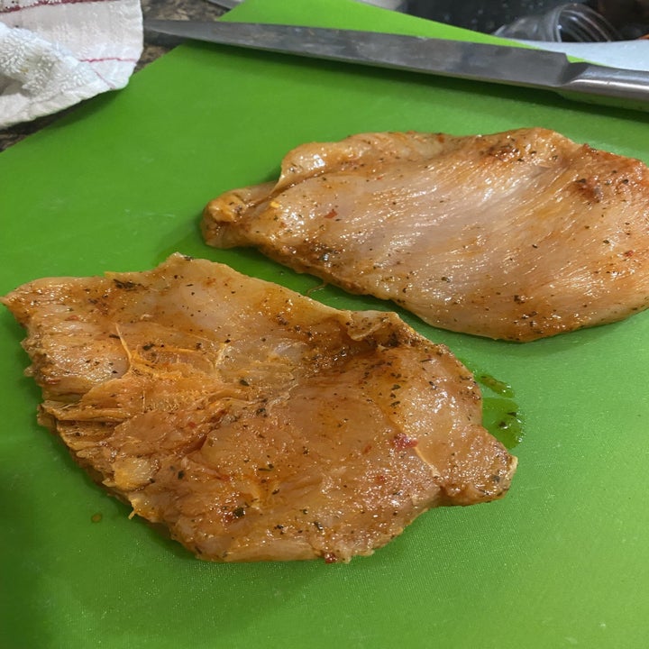 the marinated chicken on a cutting board outside of the packets