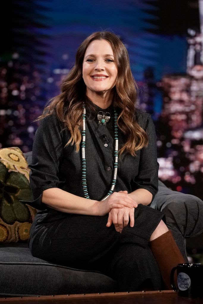 Drew smiling as she sits on the couch on The Tonight Show with Jimmy Fallon