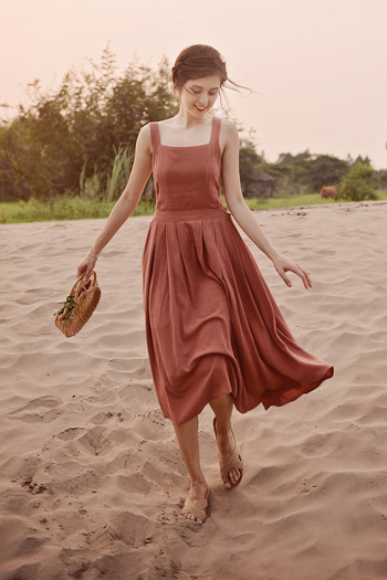 model in the sleeveless square neck rust color midi dress