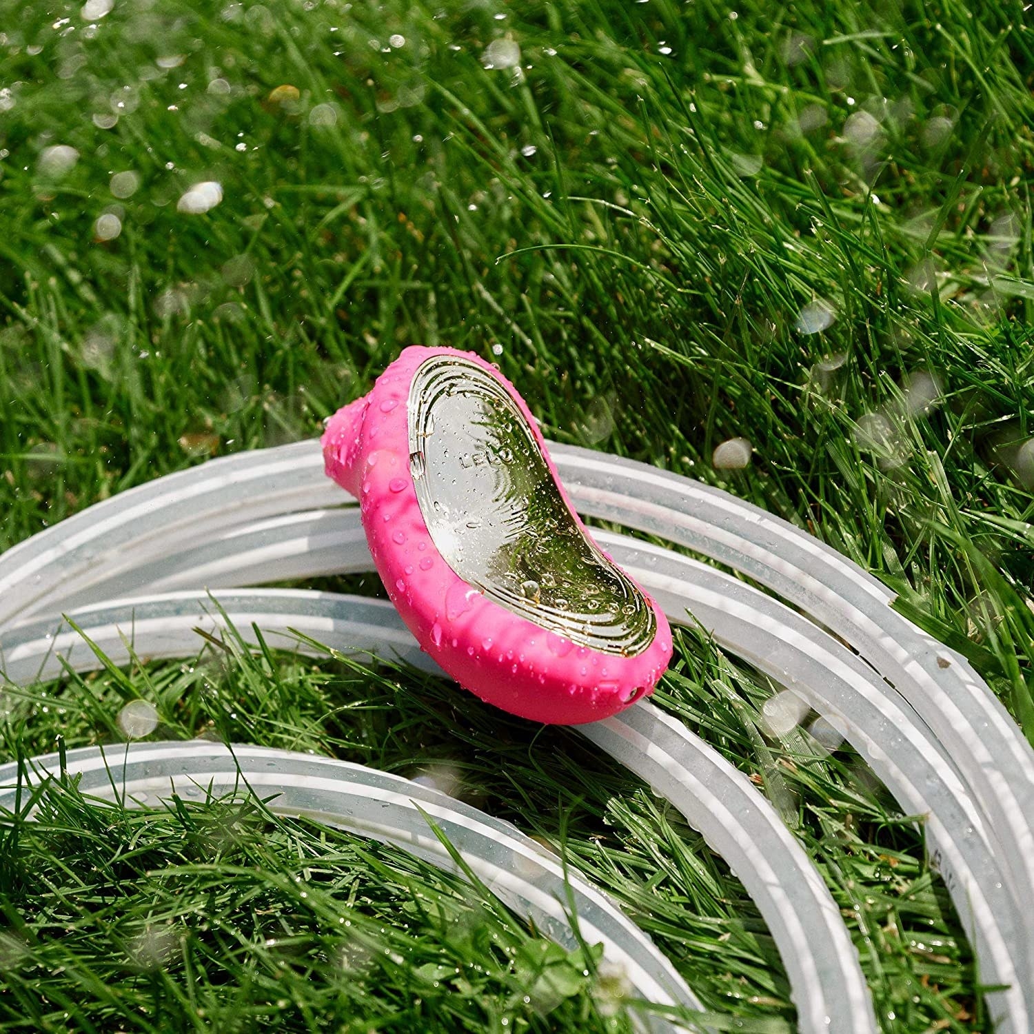 The massager on a garden hose in the grass