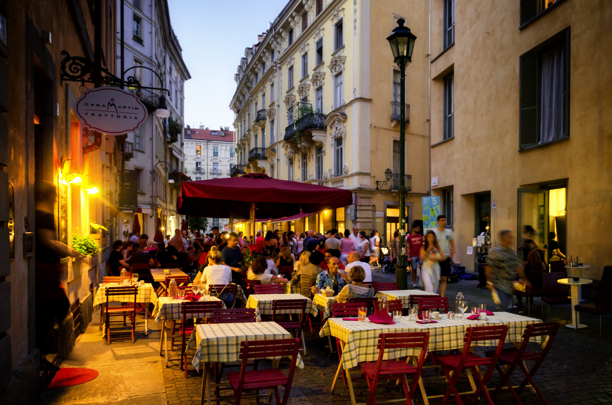 a crowded restaurant with outdoor seating