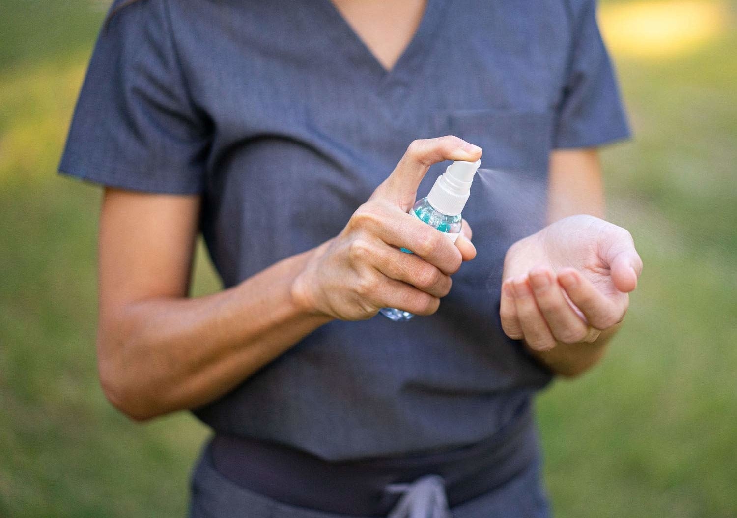 a model sprays the surgicept hand sanitizer on their hands