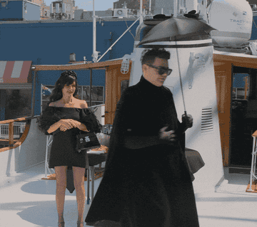 a person spinning in an all black outfit from a scene in my unorthodox life